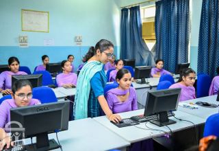 gn-college-nursing-computer-teacher-helping-student-far-watermark