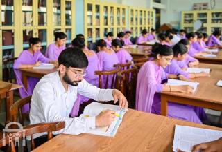 male-nursing-student-college-library-studying-watermark