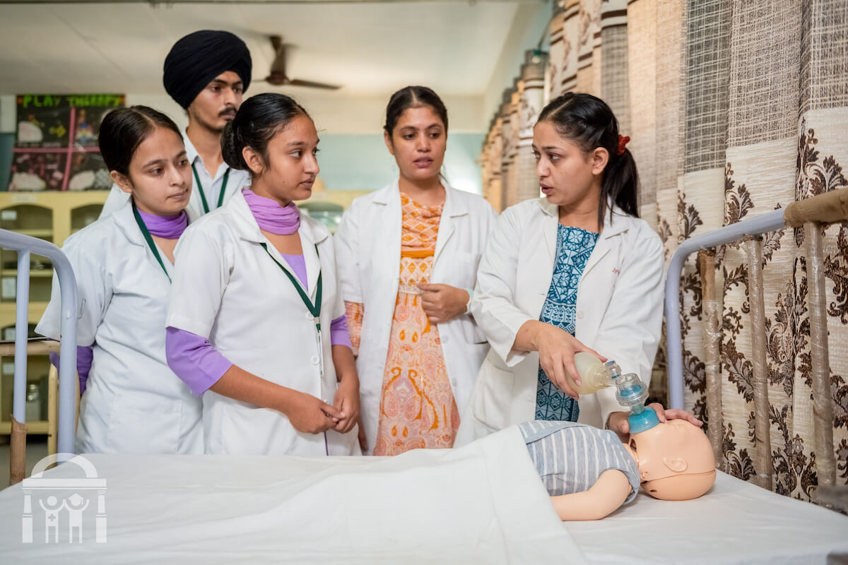 Students learning child resuscitator skills at Guru Nanak College of Nursing in Dhahan Kaleran near Banga and Phagwara