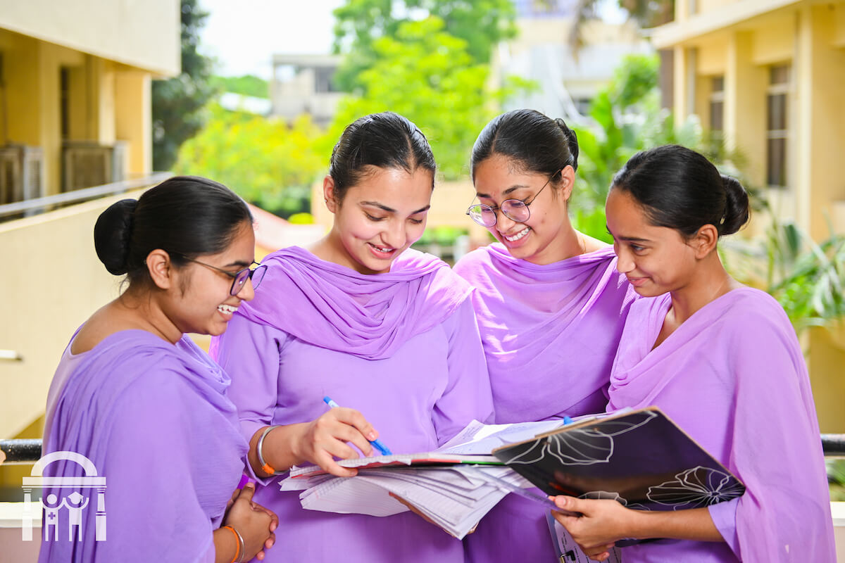 Nursing students sharing notes and studying outdoors at Guru Nanak College of Nursing in Dhahan Kaleran near Banga