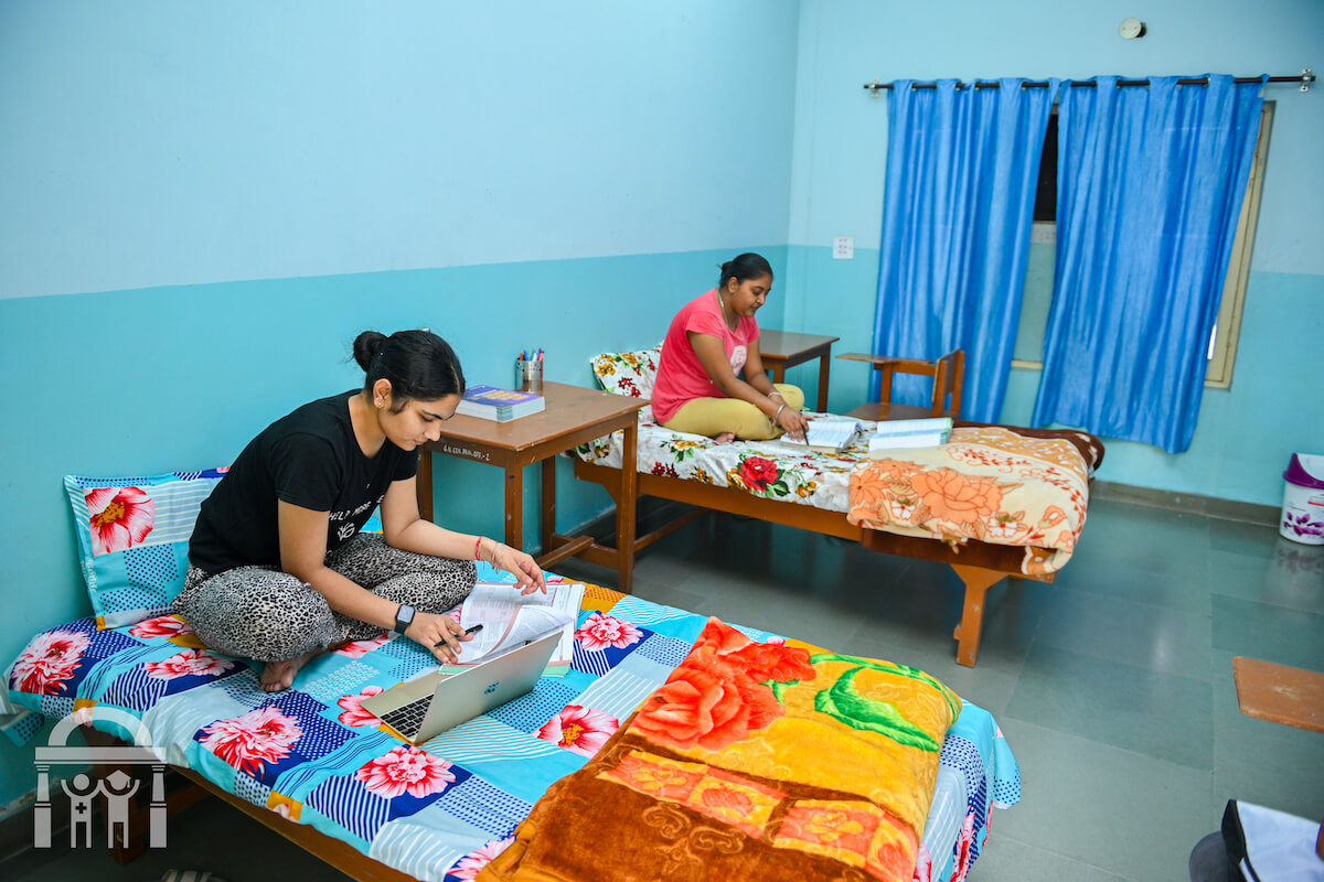 Nursing students in hostel at Guru Nanak College of Nursing studying on beds