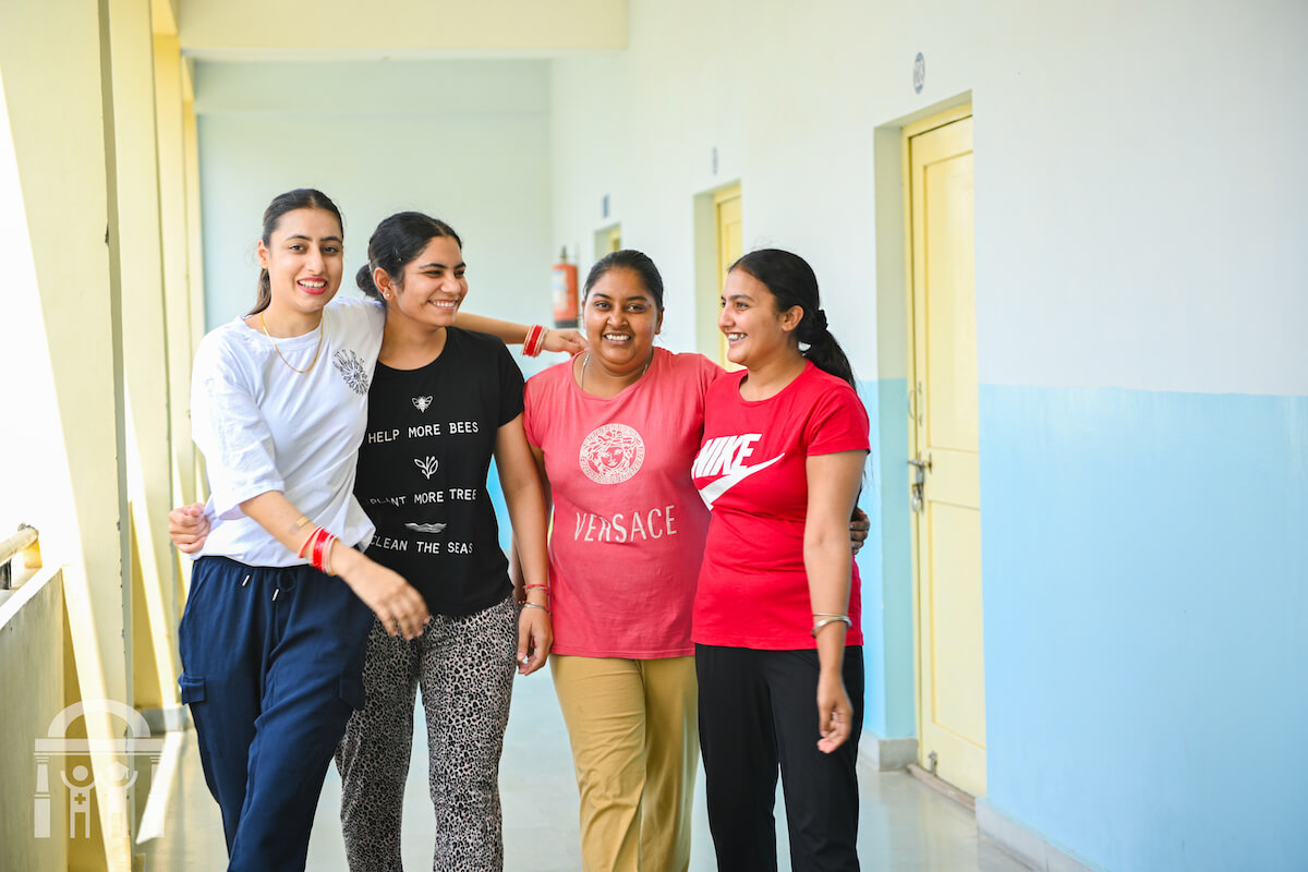 Nursing students in hall of hostel at Guru Nanak College of Nursing talking and happy