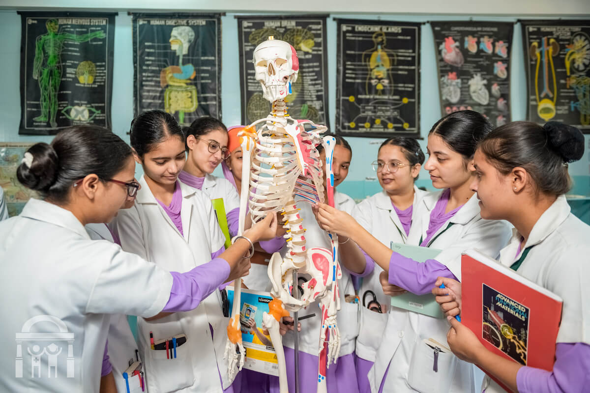 Students viewing skeleton in nursing anatomy lab at Guru Nanak College of Nursing in Dhahan Kaleran near Banga and Phagwara