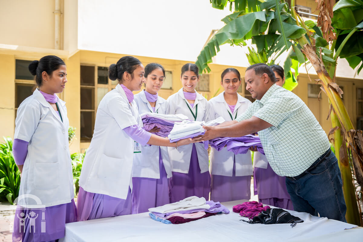 Students picking up laundry from washerman service at Guru Nanak College of Nursing